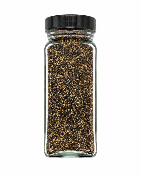 A clear glass spice jar filled with coarse black pepper, sealed with a black ribbed screw cap, shown against a plain white background.