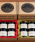 Gift boxes showing 4 pinch jars. one gift box has red tissue paper, the other gold tissue paper