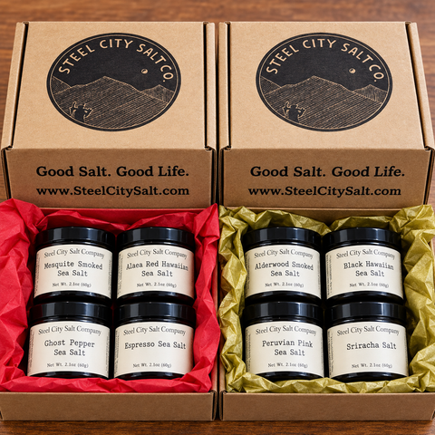 Gift boxes showing 4 pinch jars. one gift box has red tissue paper, the other gold tissue paper