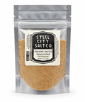 Steel City Salt Co. Roasted Garlic Granulated seasoning in a silver resealable stand-up pouch with a cream label, shown on a white background.