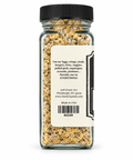 A clear glass spice jar with a black ribbed lid, showing the back of the label. The label is cream-colored with black text detailing usage suggestions for eggs, wings, steak, burgers, fries, veggies, pulled pork, asparagus, avocado, potatoes, the brand Street City Ball, address, website, and 'Made in USA'.