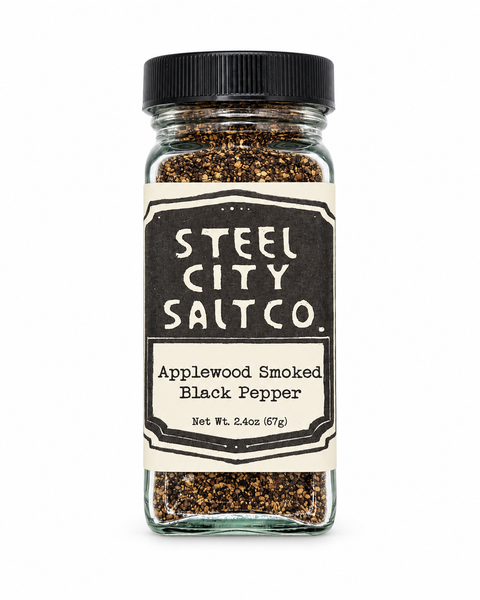 Steel City Salt Co. Applewood Smoked Black Pepper in a clear glass jar with a black lid and cream label, shown on a white background.