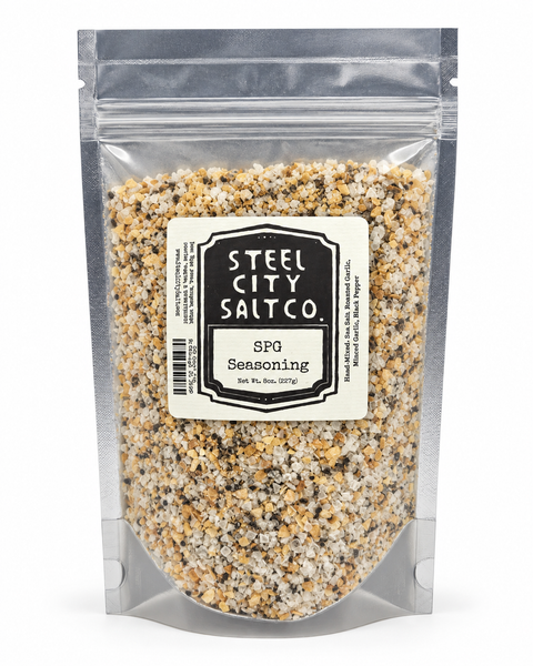 Steel City Salt Co. SFG Seasoning in a clear resealable stand-up pouch, showing a speckled seasoning mix of beige, brown, black, and white crystals.